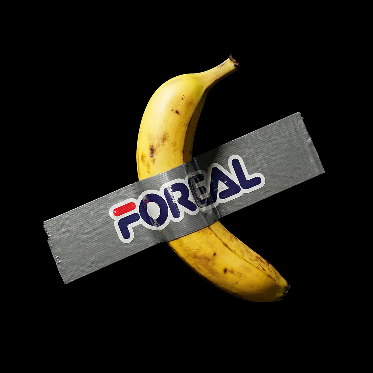 A banana taped to a black surface with duct tape and a die-cut vinyl sticker labeled "FOREAL" in bold, blue and red font.